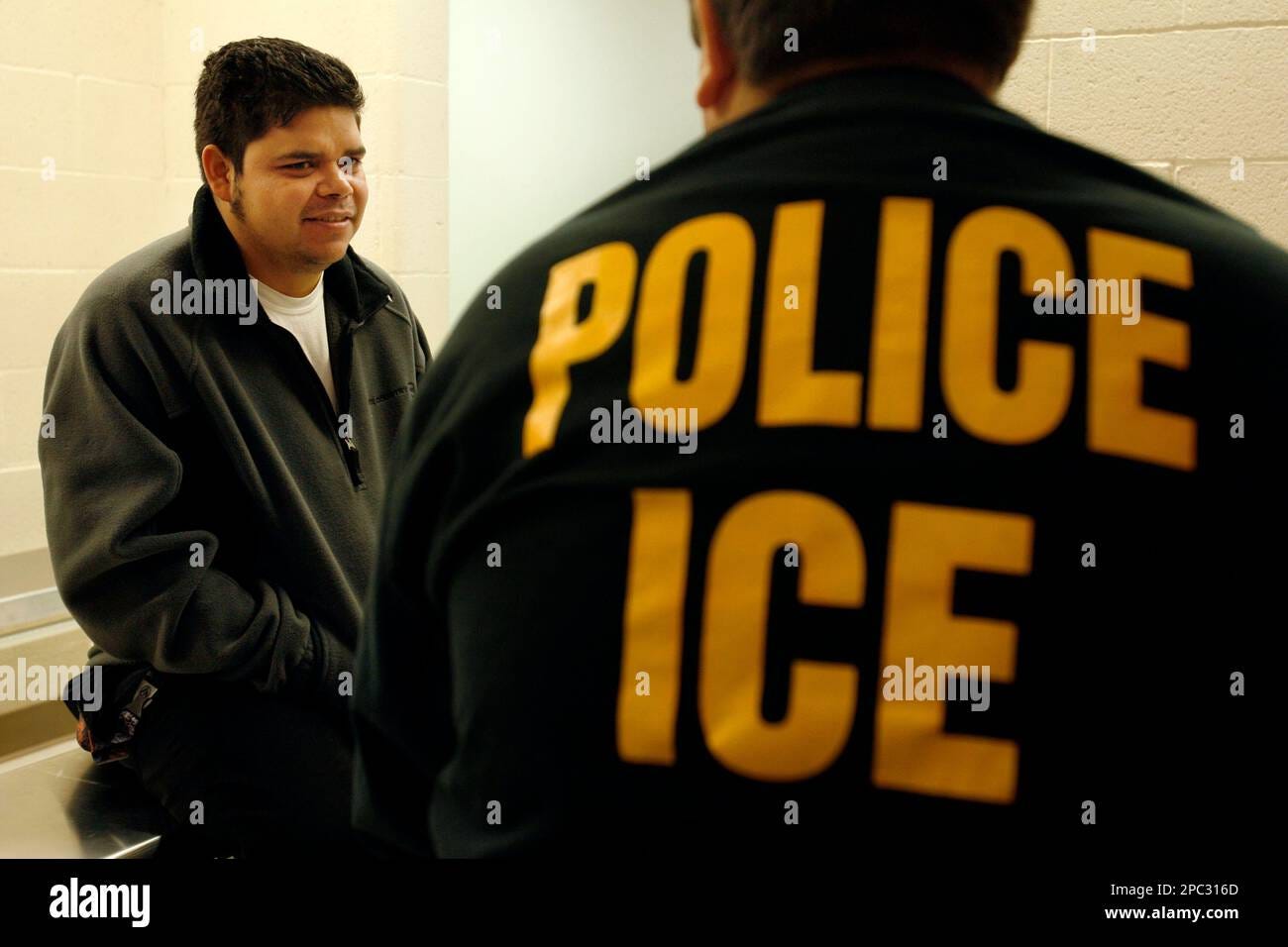 Adan Garcia, 20, left, from San Luis-Santa Barbara, Honduras is interviewed  by an Immigration and Customs Enforcement (ICE) officer after a raid in  Santa Ana, Calif., Wednesday, Jan. 17, 2007. The week-long
