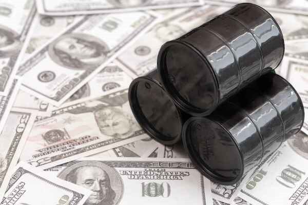 Barrels of oil against the background of American dollars Barrels of oil against the background of American dollars