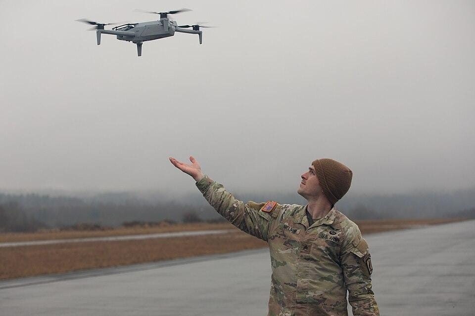 A person in military uniform and hat looking at a drone
AI-generated content may be incorrect. A person in military uniform and hat looking at a drone
AI-generated content may be incorrect.