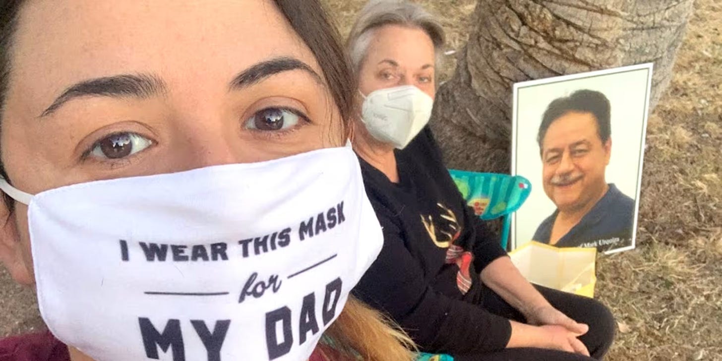 Urquiza, masked, with a photo of her father Urquiza, masked, with a photo of her father