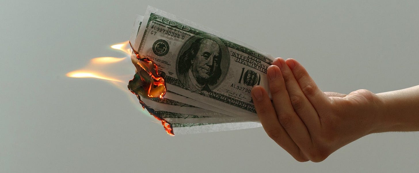 time lapse photography of several burning US dollar banknotes time lapse photography of several burning US dollar banknotes