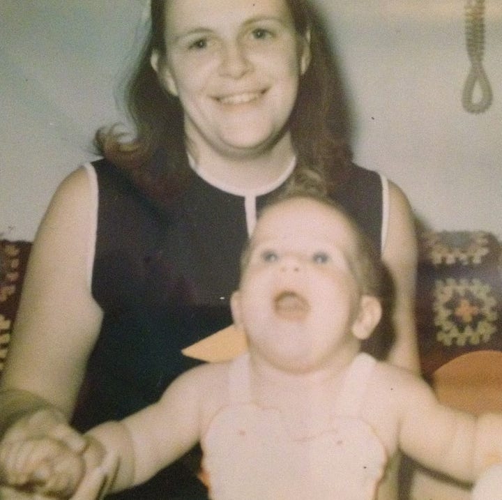 A series of photos of Vickie and her mother Sue. One is of Vickie as a baby and her mother sitting behind her on a couch, another is Sue with a black sweater and a purple scarf; a third is from an MS fundraiser and says "Friends of Sue" and features a photo of Sue in shorts and tee shirt at a beach in Aruba; and the fourth is of Vickie wearing a graduation cap and gown, smiling in a photo with her mother.