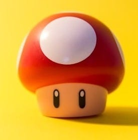 a small mushroom sitting on top of a yellow surface a small mushroom sitting on top of a yellow surface