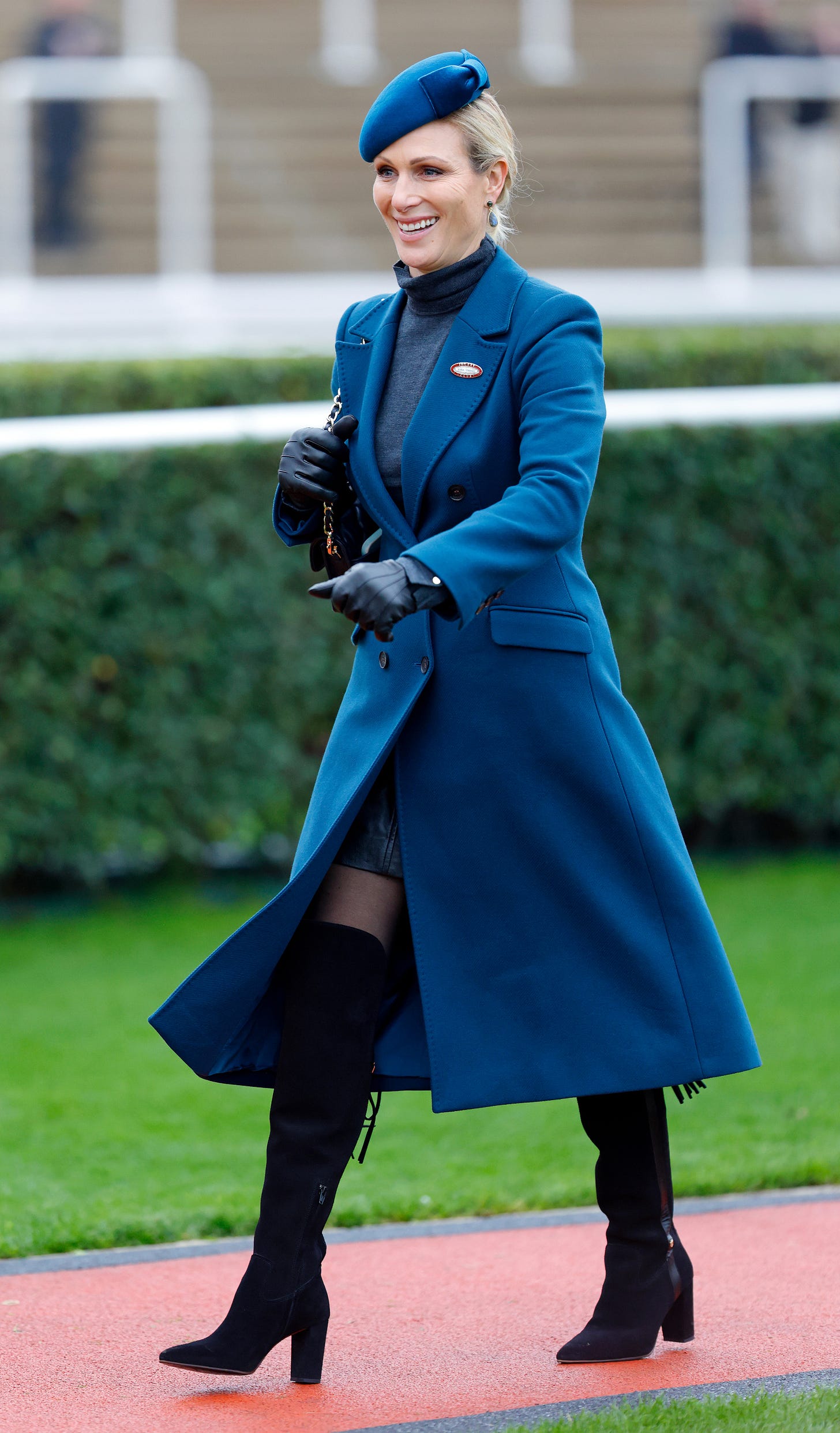 Zara Tindall wearing electric blue and black boots