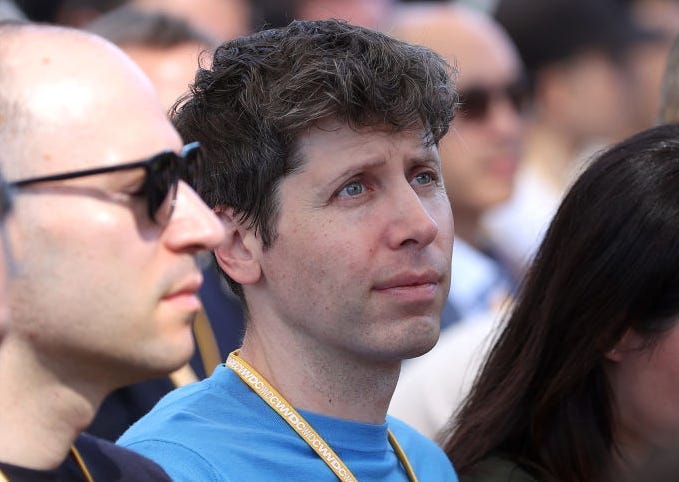 Sam Altman in a blue shirt