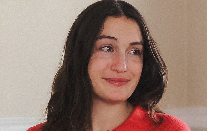 Two portraits of woman. Kailea is wearing a cowry shell necklace, standing in front of a rose bush. Kate is looking over her shoulder to a point to the left of the camera, wearing a red blouse. 