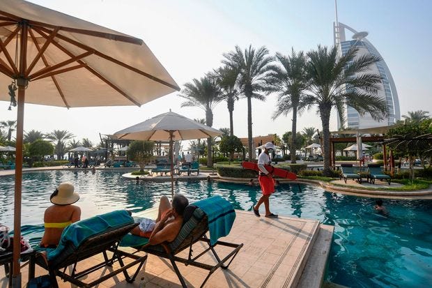 Tourists at the Al Naseem hotel in Dubai. The city reopened to tourists in July. Tourists at the Al Naseem hotel in Dubai. The city reopened to tourists in July.