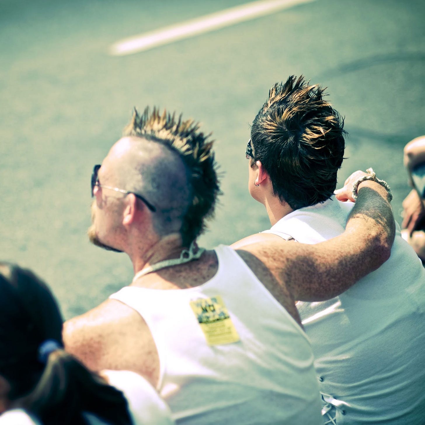 While sitting on a curb in downtown Vancouver, two people are pictured watching the 2010 Vancouver Pride parade. One person has their arm around the shoulder of another. B.W. Homer/ Photo of the day, the Georgia Straight While sitting on a curb in downtown Vancouver, two people are pictured watching the 2010 Vancouver Pride parade. One person has their arm around the shoulder of another. B.W. Homer/ Photo of the day, the Georgia Straight