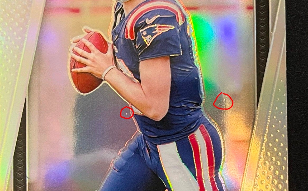 Manufacturer dimples on PSA grading submission on 2024 Drake Maye Prizm Silver Rookie Card #329. Manufacturer dimples on PSA grading submission on 2024 Drake Maye Prizm Silver Rookie Card #329.