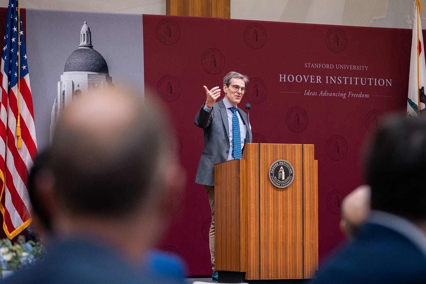 Senior Fellow John Cochrane welcomes attendees of the 2026 Hoover Monetary Policy Conference in Blount Hall on May 7, 2026. (Patrick Beaudouin)