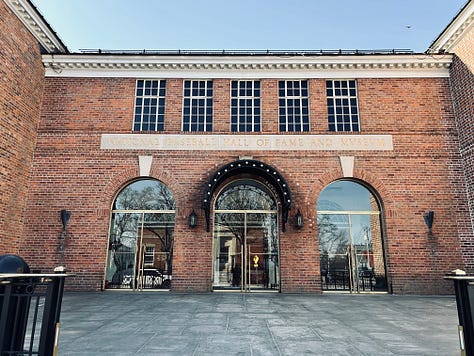 building, statues, doors, sky, street, pavement