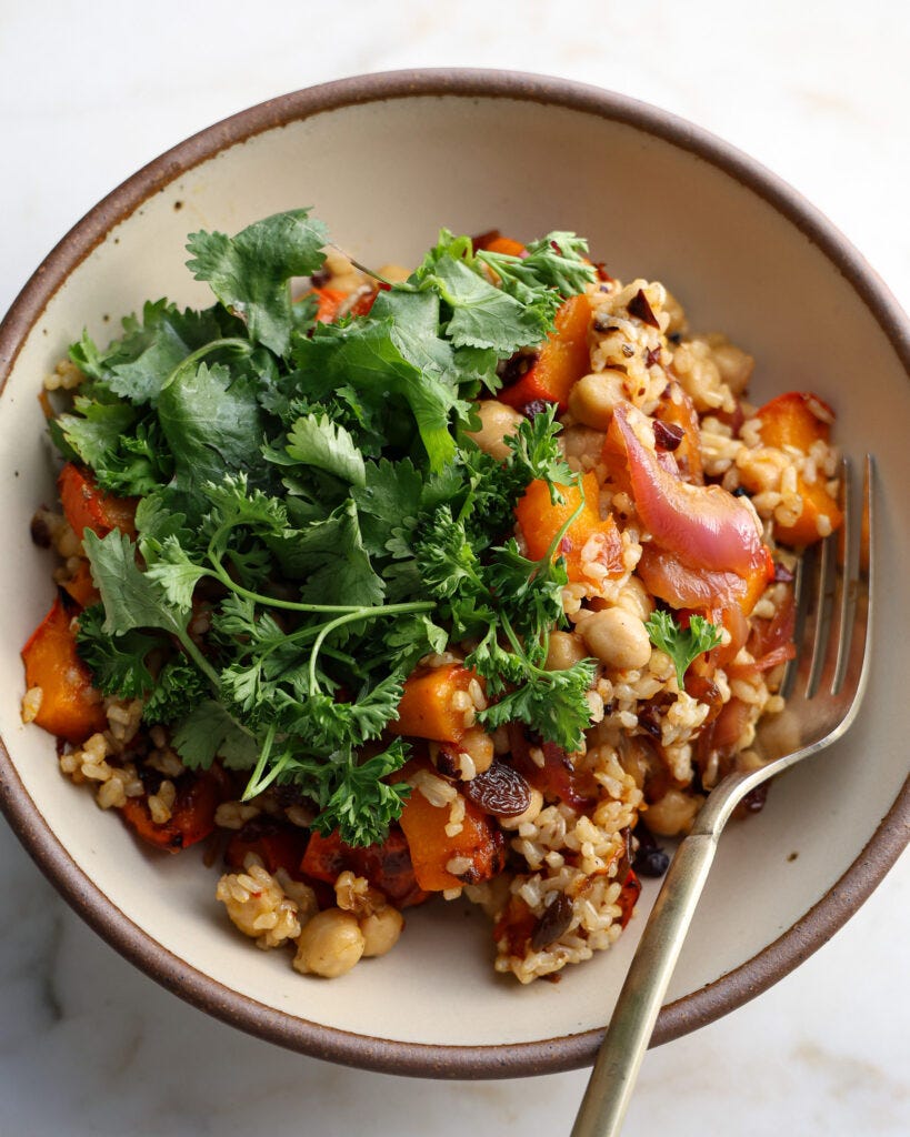 Kabocha squash bowl with a gastrique, plated and up close to show off the colors of the grain bowl 