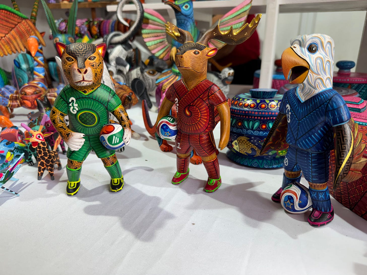 Three alebrijes depicting soccer players.