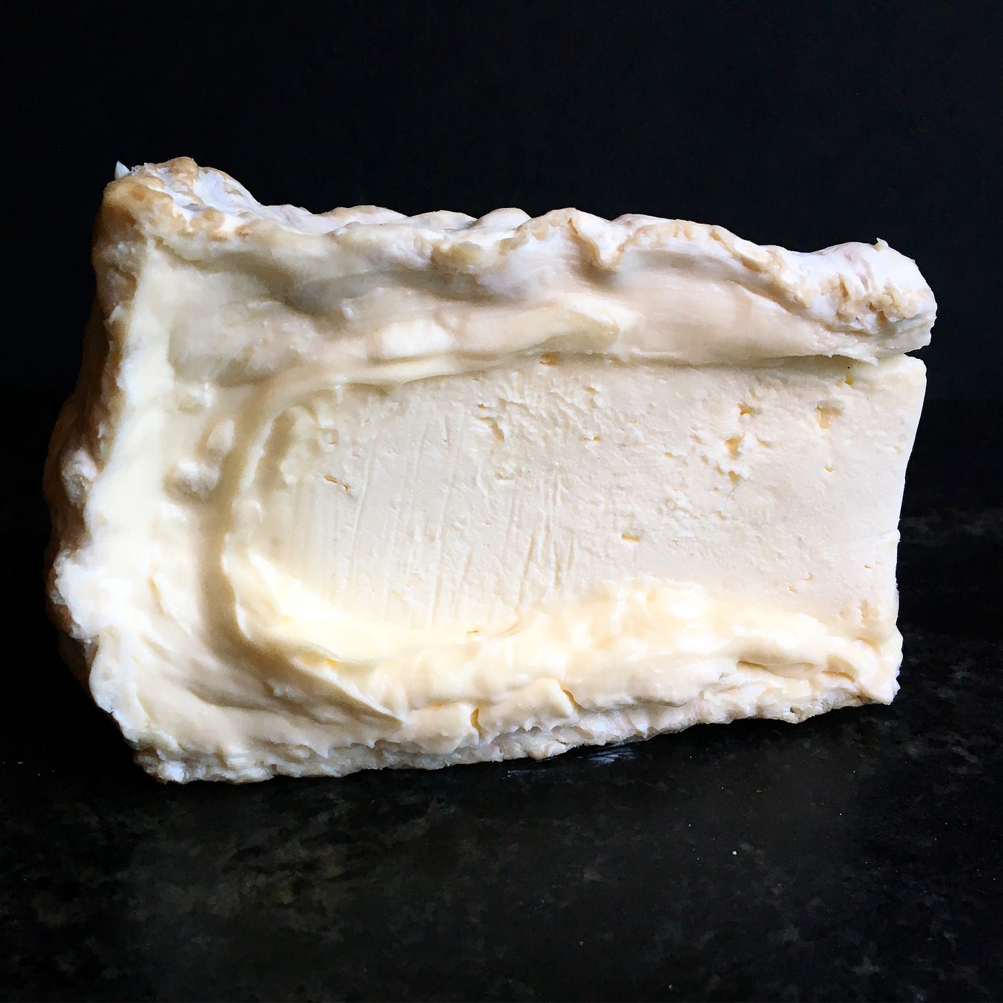 A ripe wedge of triple cream brie A ripe wedge of triple cream brie