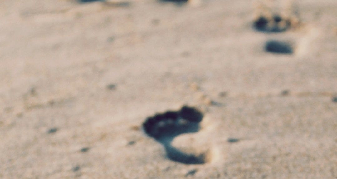 foot prints on beach sand