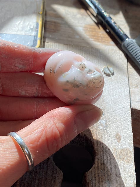 man carved out of pink opal