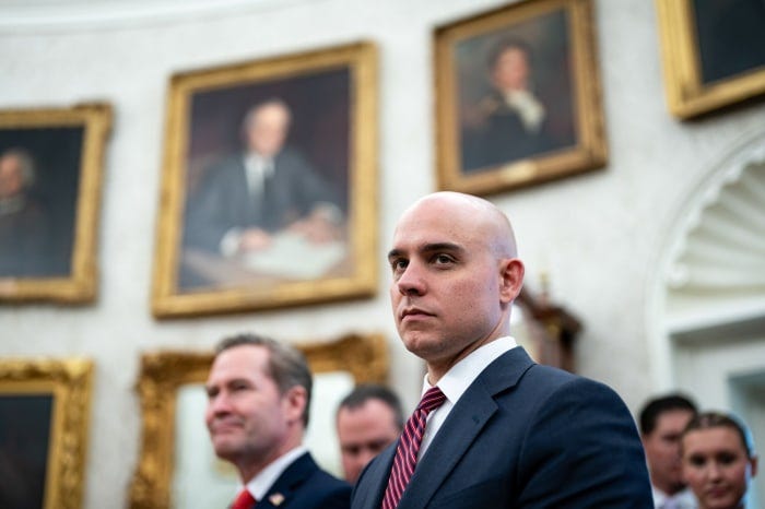 James Blair, in striped tie, attending a meeting.