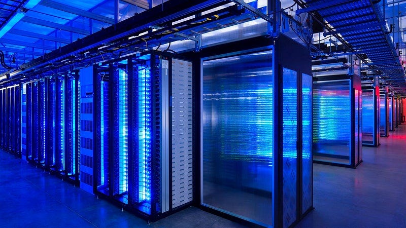 A brightly lit interior of a hyperscale data center with rows of servers emitting blue and red lights, showcasing advanced infrastructure for computing and storage. A brightly lit interior of a hyperscale data center with rows of servers emitting blue and red lights, showcasing advanced infrastructure for computing and storage.