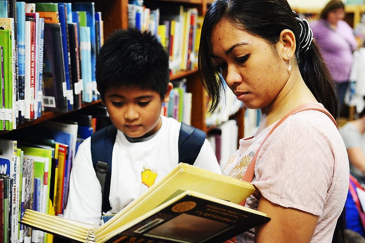 children holding books, reading books, and attending a presentation during a variety of public summer reading programs