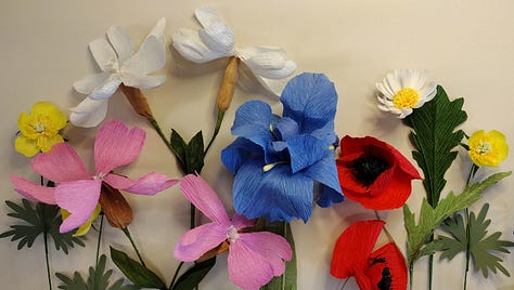 A range of different paper flowers from brightly coloured fantasy flowers to detailed wildflowers
