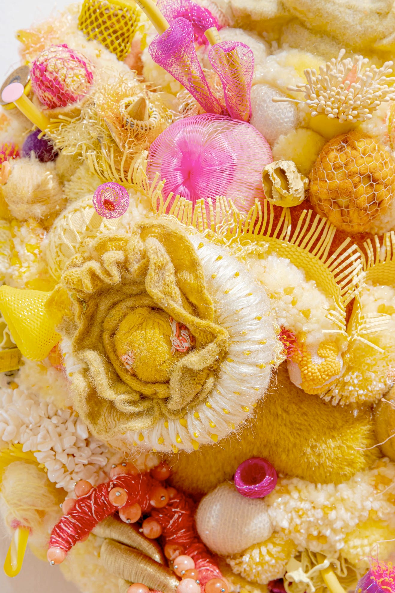 deep yellow, pink fabric, fibre and trash come together to make something monstrous and gorgeous and unknowable