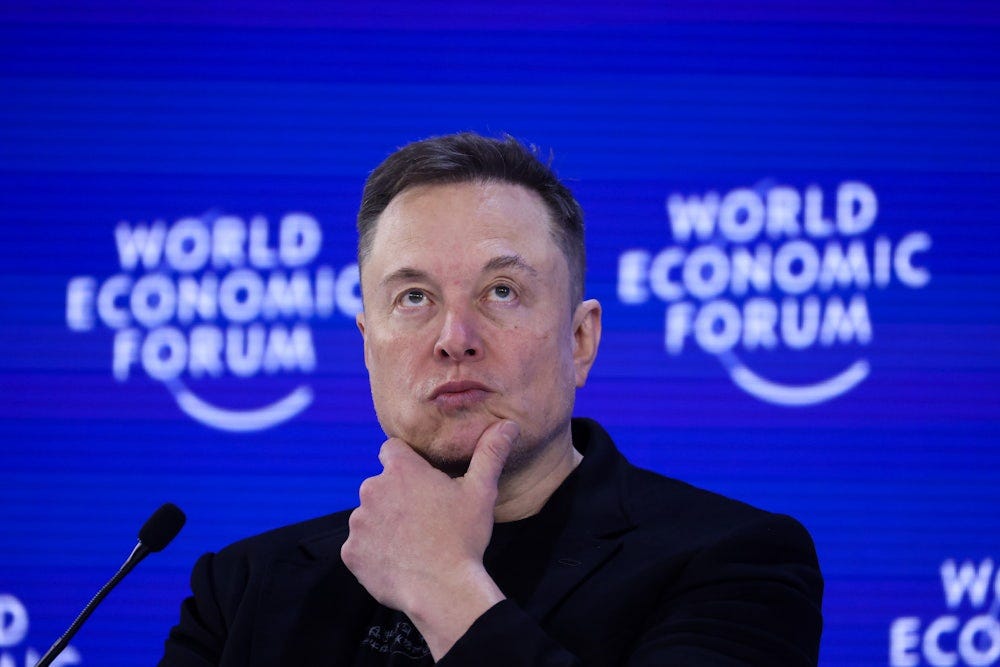 Elon Musk holds a hand on his chin