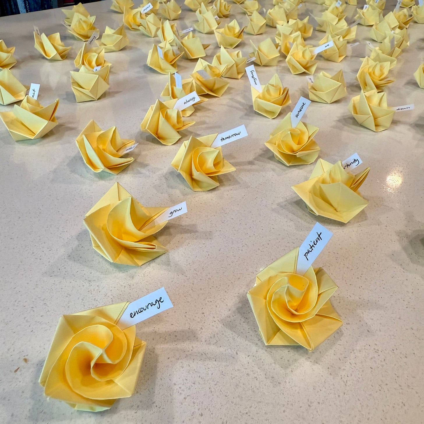 100 yellow origami roses with a word tucked into each one