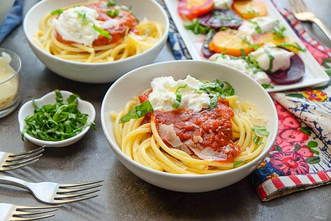 Plate of chicken breast with wild rice and green beans; beef & broccoli stir fry in a white bowl; bowl of bucatini pasta with herb-whipped ricotta and marinara sauce