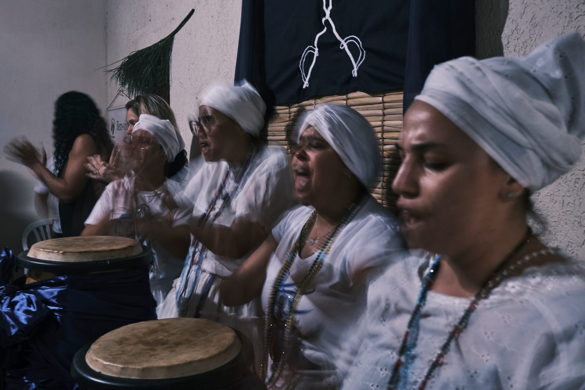 Spiritist practitioners in white during a session in Brazil, highlighting charity and community—a vibrant example of Spiritism in the world. Position: In global section for cultural relevance.