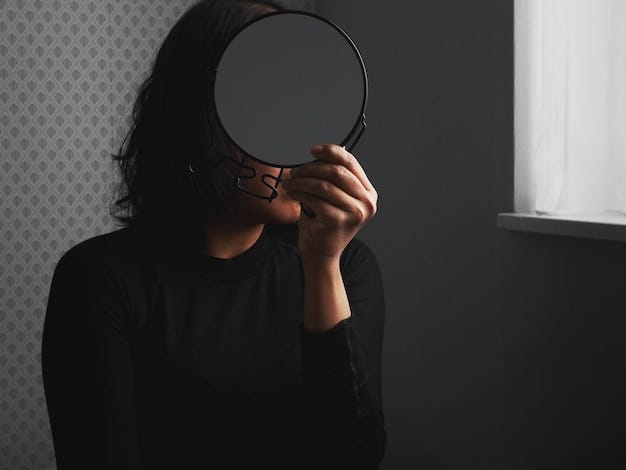 Close-up of woman looking into mirror at home | Premium Photo