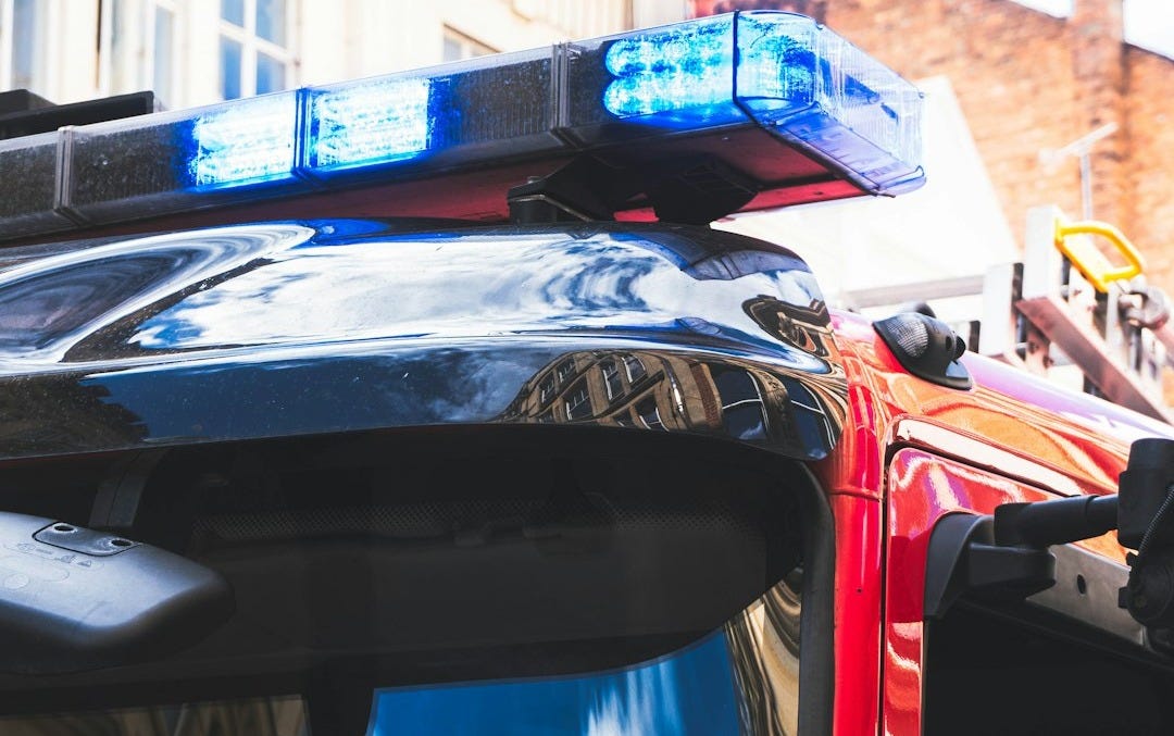 black and blue car in front of red car black and blue car in front of red car