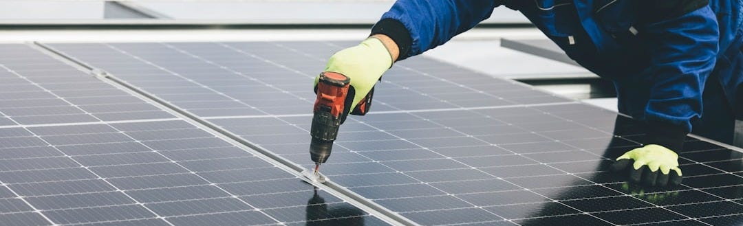 a person working on a solar panel a person working on a solar panel
