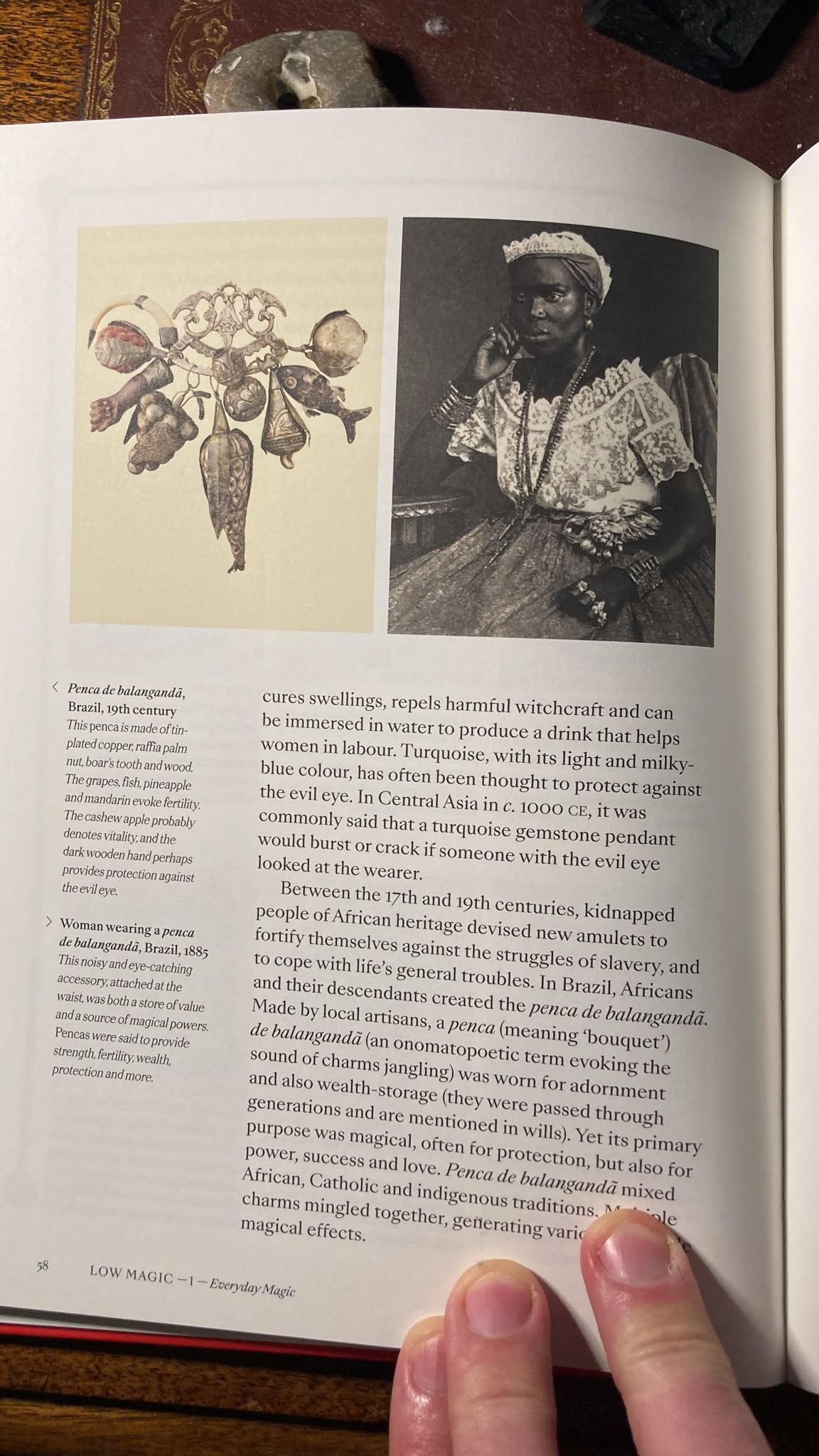 Page from Magick illustrating a nineteenth-century Brazilian penca de balangandã charm and a photograph of a woman wearing one, exploring protective amulets, fertility, prosperity and Afro-Brazilian magical traditions. Page from Magick illustrating a nineteenth-century Brazilian penca de balangandã charm and a photograph of a woman wearing one, exploring protective amulets, fertility, prosperity and Afro-Brazilian magical traditions.