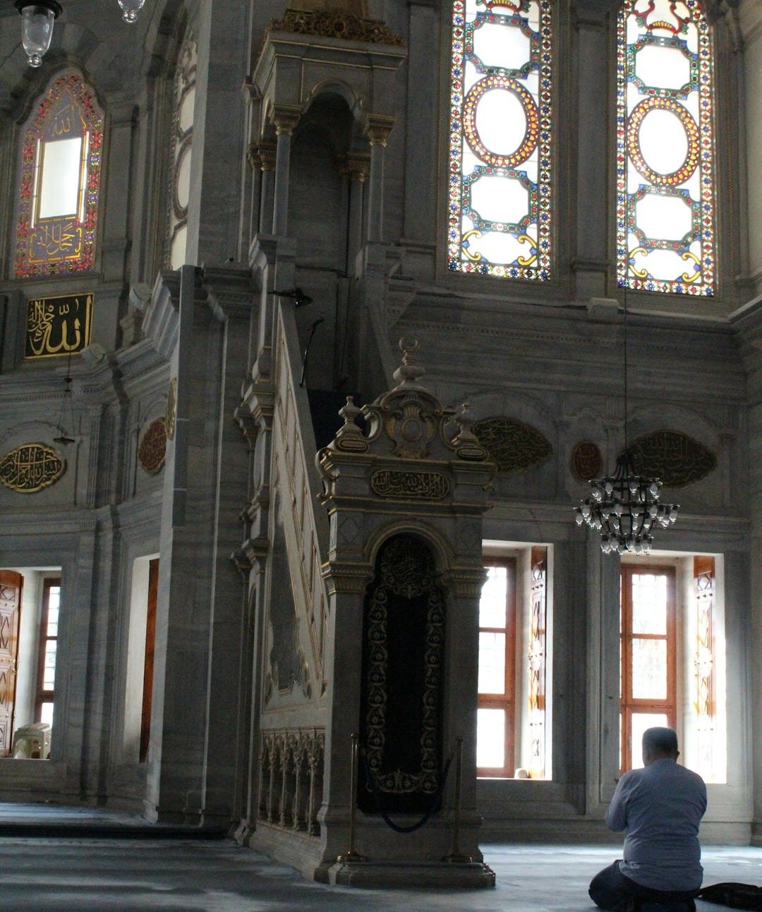 Man prays in an ornate mosque.