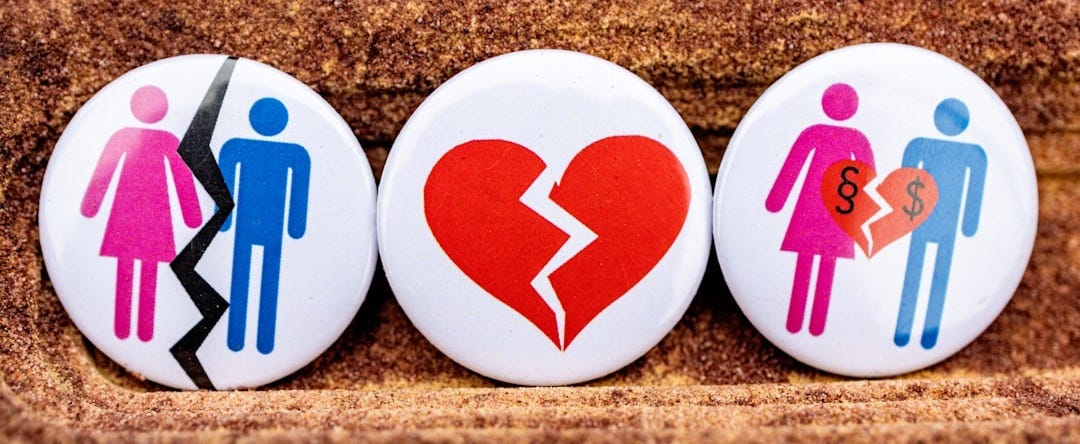 three buttons depicting a broken heart, a man and a woman three buttons depicting a broken heart, a man and a woman