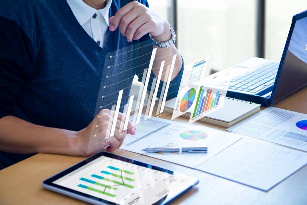 Reviewing financial reports in returning on investment analysis Businessman with virtual reality graphics is deeply reviewing financial reports for a return on investment, ROI, or investment risk analysis. financial workseet stock pictures, royalty-free photos & images Reviewing financial reports in returning on investment analysis Businessman with virtual reality graphics is deeply reviewing financial reports for a return on investment, ROI, or investment risk analysis. financial workseet stock pictures, royalty-free photos & images