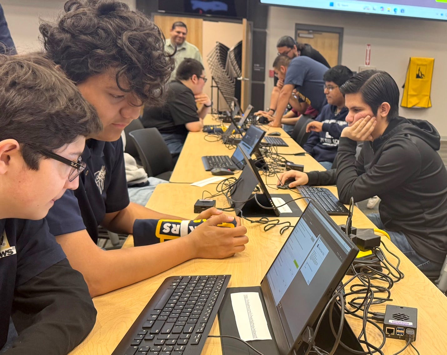 A group of people sitting at a table with computers

AI-generated content may be incorrect.