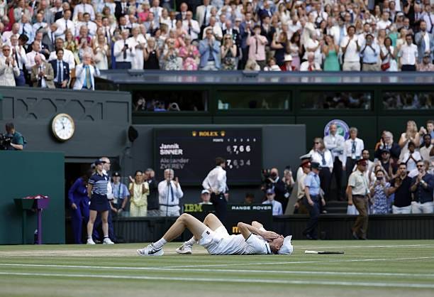 Jannik Sinner of Italy lies on the court after beating Alexander Zverev of Germany in the men's singles final at the Wimbledon tennis tournament in...