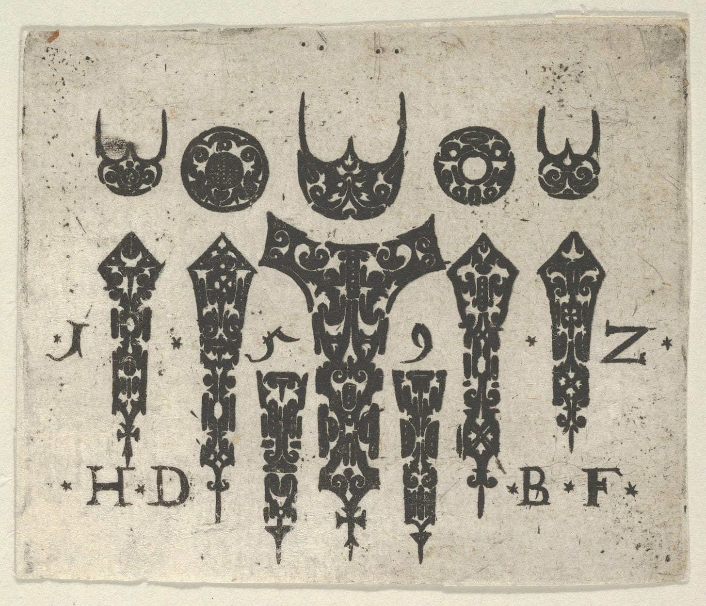 A black and white antique print of decorative shapes and letters