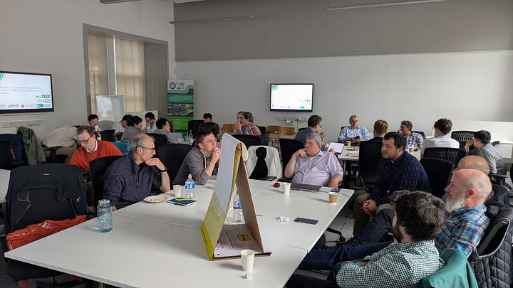 Five photographs of workshop attendees around tables in discussion, and a collage of speakers in front of presentations