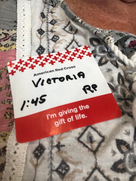 Three photos: A nametag with Victoria”; an image from teh front of a t-shirt that looks like a droplet and contains many images of teh characters Woodstock from the Peanuts cartoon; an image of Snoopy and Woodstock with the words, “A litt;e goes a long way. Thank you for giving blood.”