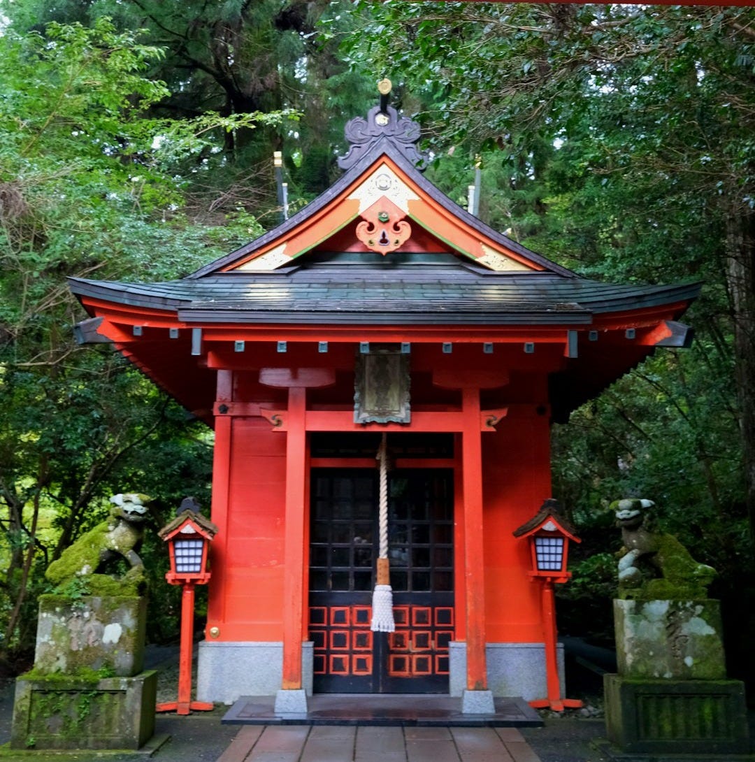 A red building with a bell on top of it