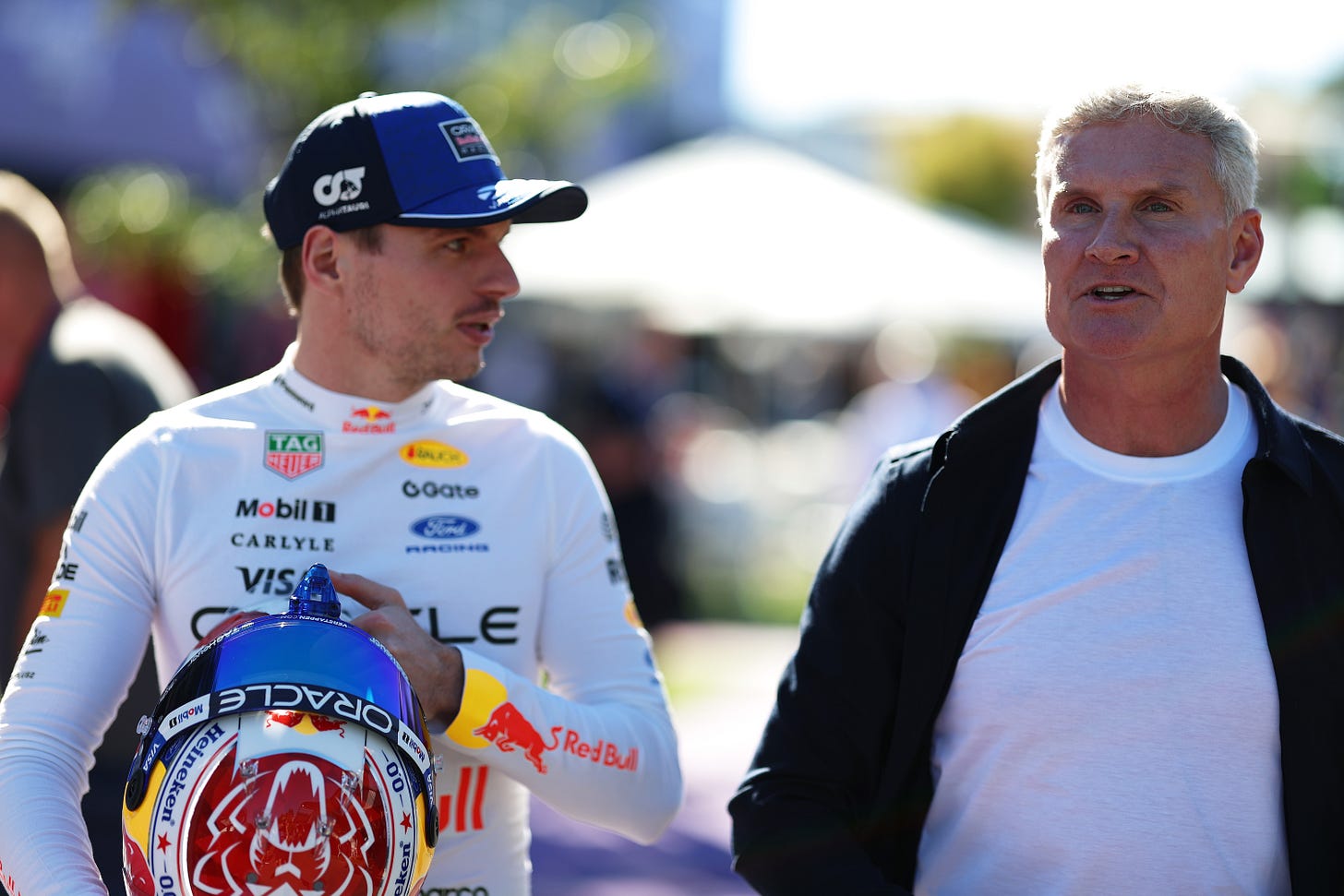 Max Verstappen walking in the F1 paddock with David Coulthard