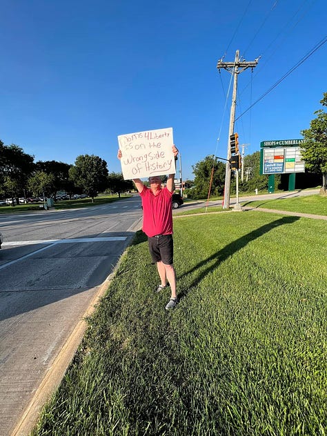 people holding signs in support of freedom of speech and access to information