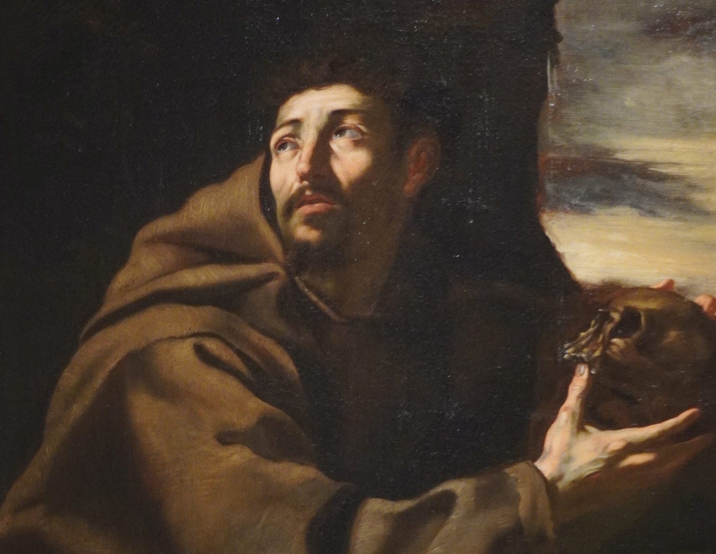 A painting in the Montserrat collection of a man holding a human skull