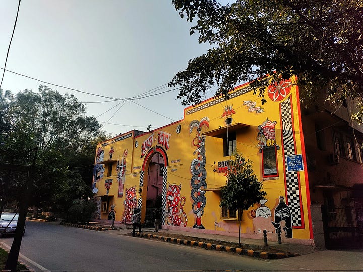 4 images of colourful murals of walls in Delhi
