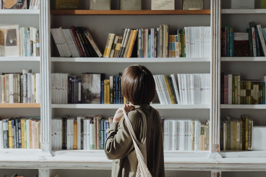 girl looking at books at bookstore