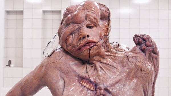 Elisasue, the grotesque body horror creature in The Substance, formed from failed beauty ideals — a visual metaphor of self-destruction through societal pressure.