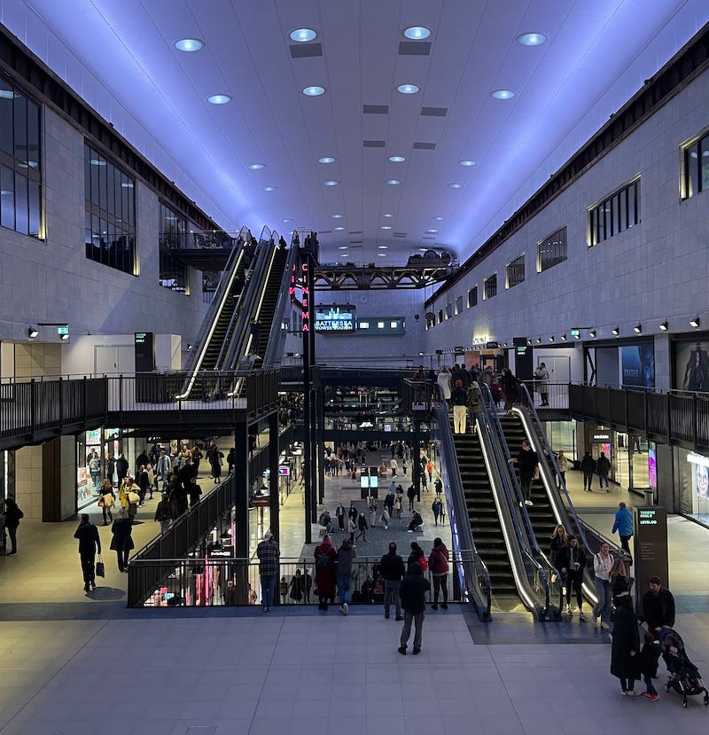 The interior of the Battersea power station shopping mall, which has a cinema, some escalators and kind of bluish lighting The interior of the Battersea power station shopping mall, which has a cinema, some escalators and kind of bluish lighting