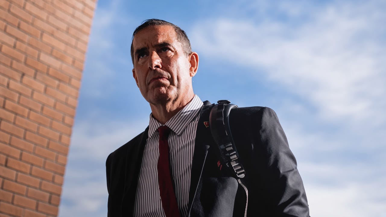 Wisconsin Badgers head coach Luke Fickell, wearing a suit, walking into the stadium before a game. Wisconsin Badgers head coach Luke Fickell, wearing a suit, walking into the stadium before a game.